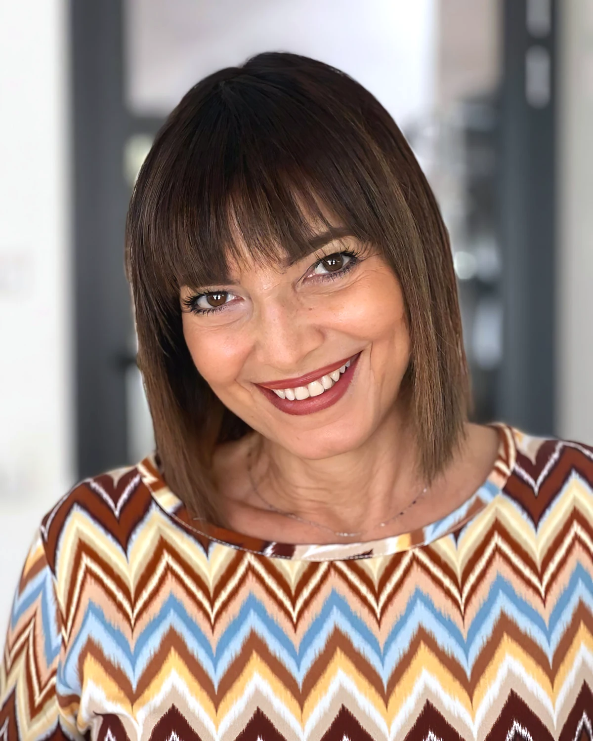 1724076093 458 Adopt mid length layered hair with bangs for women aged 50.webp - Adopt mid-length layered hair with bangs for women aged 50 to look younger! Inspirational photos